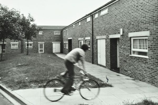 Andover: boy rides a bicycle on a housing estate, image © London Metropolitan Archives (City of London).